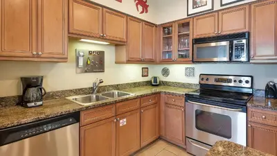 a kitchen with wooden cabinets and a sink at Villas At Seagrove C401 in Santa Rosa Beach