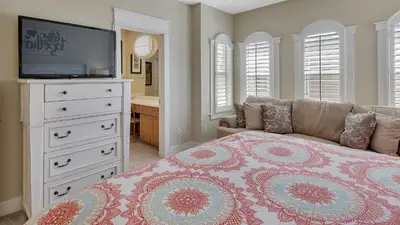 a bedroom with a bed with a television and a dresser at Villas At Seagrove C401 in Santa Rosa Beach