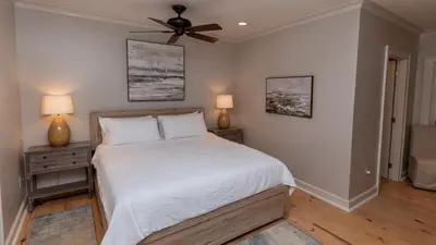 a bedroom with a bed and a ceiling fan at Tranquility at A La Paix in Panama City Beach
