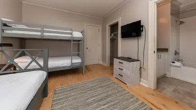 a bedroom with two bunk beds and a flat screen tv at Tranquility at A La Paix in Panama City Beach