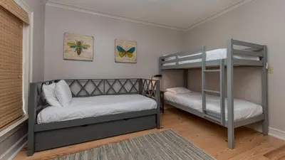 a bedroom with two bunk beds and a ladder at Tranquility at A La Paix in Panama City Beach