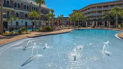 a swimming pool with four birds in the water at Tranquility at A La Paix in Panama City Beach