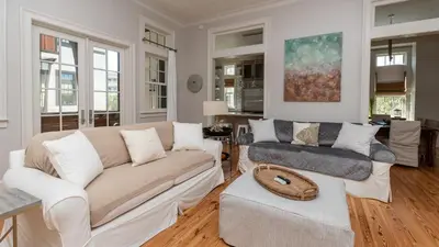 a living room with a couch and a chair at Tranquility at A La Paix in Panama City Beach