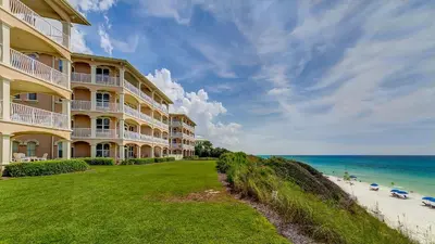 a building on the beach next to the ocean at Monterey Condos A201 in Panama City Beach