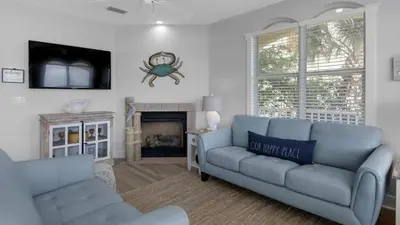 a living room with a blue couch and a fireplace at Monterey Condos A201 in Panama City Beach