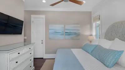 a bedroom with a bed and a flat screen tv at Emotional Rescue in Inlet Beach