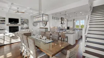 a kitchen and dining room with a table and chairs at Emotional Rescue in Inlet Beach