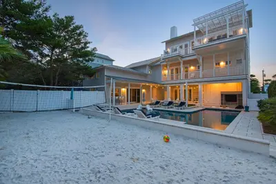 a large house with a swimming pool in front of it at Emotional Rescue in Inlet Beach