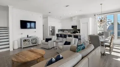 a living room with a couch and a table at The Mirage in Seacrest