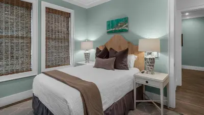 a bedroom with a bed and a table with a lamp at Sea Echo in Santa Rosa Beach