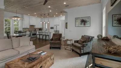 a living room with a couch and a table at Sea Echo in Santa Rosa Beach
