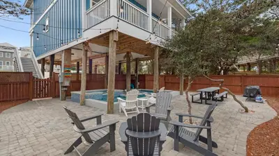 a patio with a deck and chairs and a pool at Khalee-sea in Seacrest