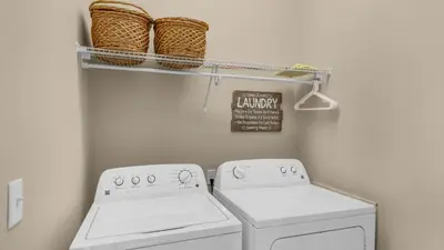 a laundry room with two washing machines and baskets at Khalee-sea in Seacrest