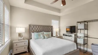 a bedroom with a large bed and a tv at Khalee-sea in Seacrest
