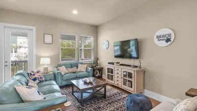 a living room with a couch and a tv at Khalee-sea in Seacrest