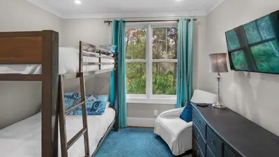 a bedroom with a bunk bed and a window at Ocean Park in Santa Rosa Beach