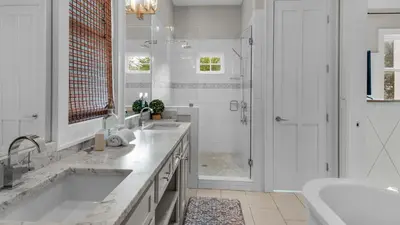 a bathroom with a tub and a sink and a shower at Ocean Park in Santa Rosa Beach