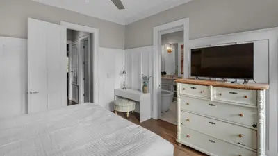 a bedroom with a bed and a tv on a dresser at Ocean Park in Santa Rosa Beach