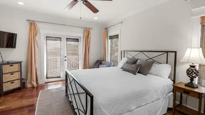a bedroom with a bed and a ceiling fan at License To Chill in Inlet Beach