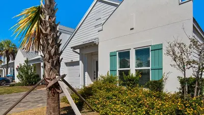 a palm tree in front of a house at Seabreeze in Panama City Beach