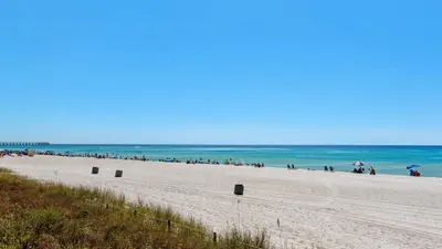 a group of people on a beach near the ocean at Seabreeze in Panama City Beach