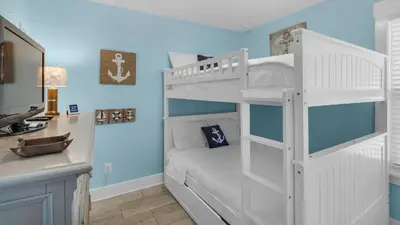 a white bunk bed in a room with a sink at Sandy Teauxs in Panama City Beach