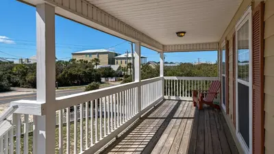 a porch with a chair and a view of the street at Beach Daze in Panama City Beach