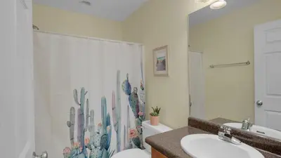a bathroom with a shower and a toilet and a sink at Beach Daze in Panama City Beach