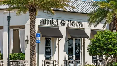 a restaurant with tables and chairs in front of a building at Beach Daze in Panama City Beach