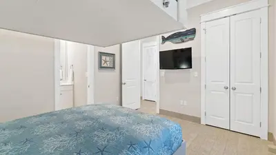 a bedroom with a bed and a flat screen tv at Seasational in Panama City Beach