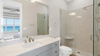 a bathroom with a toilet and a sink and a shower at Seasational in Panama City Beach