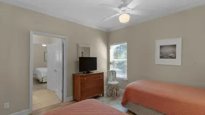 a bedroom with two beds and a flat screen tv at Seagrove By The Sea IIC in Santa Rosa Beach