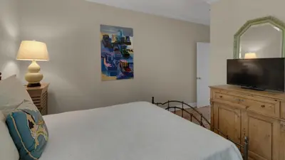 a bedroom with a bed and a flat screen tv at Seagrove By The Sea IIC in Santa Rosa Beach