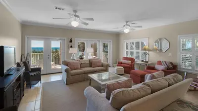 a living room with a couch and a tv at Seagrove By The Sea IIC in Santa Rosa Beach
