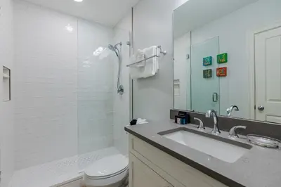 a bathroom with a sink and a toilet and a mirror at Legacy 402-Flemingo's Paradise in Seagrove Beach