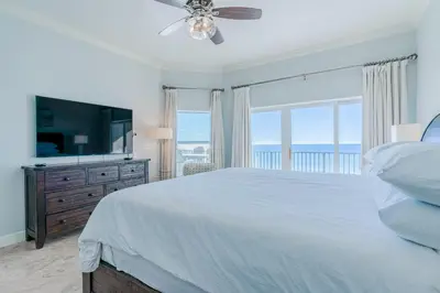 a white bedroom with a bed and a large window at Legacy 402-Flemingo's Paradise in Seagrove Beach