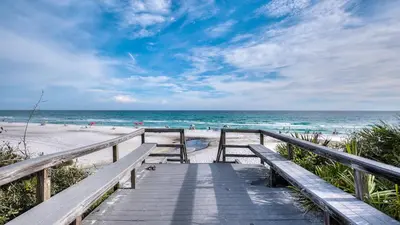 a wooden pathway to the beach with people in the ocean at Legacy 402-Flemingo's Paradise in Seagrove Beach