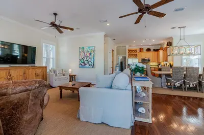 a living room with a couch and a table at Shore Thing in Rosemary Beach