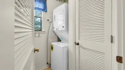 a white laundry room with a washer and dryer at Beachwood Villas 10H - Bliss at Beachwood in Santa Rosa Beach