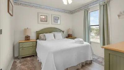 a bedroom with a bed and a window at Beachwood Villas 10H - Bliss at Beachwood in Santa Rosa Beach
