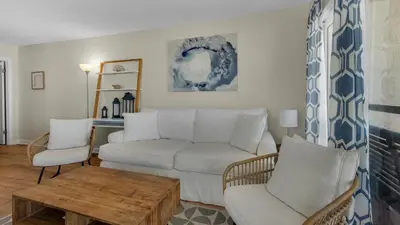 a living room with a couch and chairs and a table at Eastern Shores 106 in Santa Rosa Beach