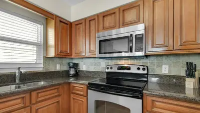 a kitchen with a stove and a microwave at Eastern Shores 106 in Santa Rosa Beach