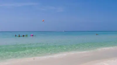 a group of people in the water at the beach at Eastern Shores 106 in Santa Rosa Beach