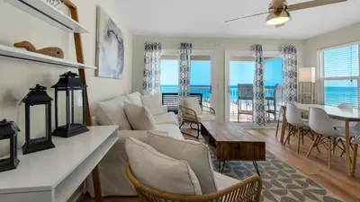 a living room with a white couch and a table at Eastern Shores 106 in Santa Rosa Beach
