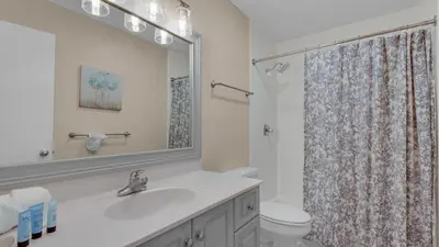 a bathroom with a sink and a toilet and a mirror at Beachwood Villas 11E - SE Seagrove in Santa Rosa Beach