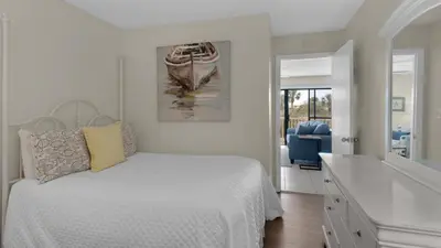 a bedroom with a bed and a bathroom with a sink at Beachwood Villas 11E - SE Seagrove in Santa Rosa Beach