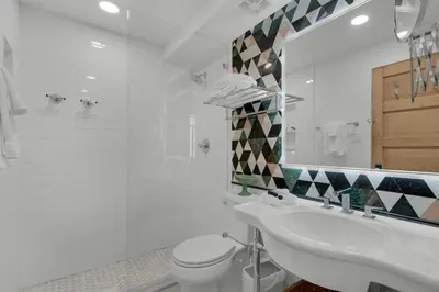 a bathroom with a sink and a toilet and a mirror at Sand Cliffs 107 in Seacrest
