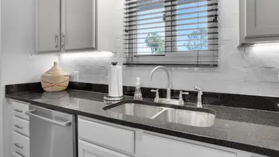 a kitchen counter with a sink and a window at Sand Cliffs 106 in Seacrest