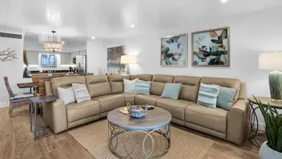 a living room with a couch and a table at Sand Cliffs 106 in Seacrest