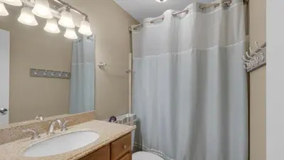 a bathroom with a shower curtain and a sink at Beachwood Villas 10C - A Wave From It All in Santa Rosa Beach